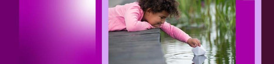 young girl on dock leaning over water